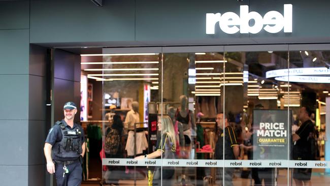 Police seen leaving the Rebel sport store in Rundle Mall. Picture Kelly Barnes