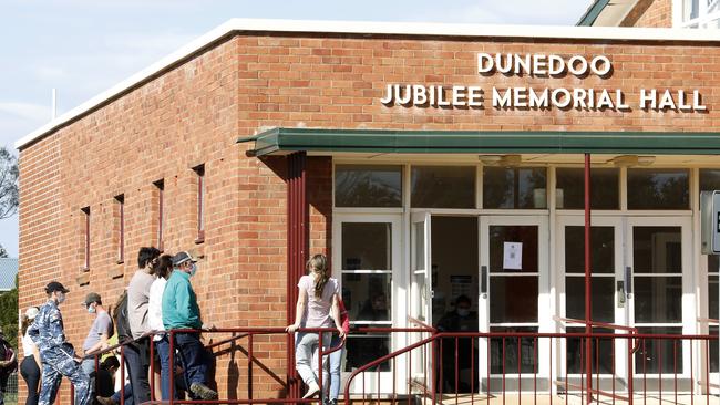 Locals line up for vaccination at the Dunedoo Jubilee Memorial Hall. Picture: Chris Pavlich