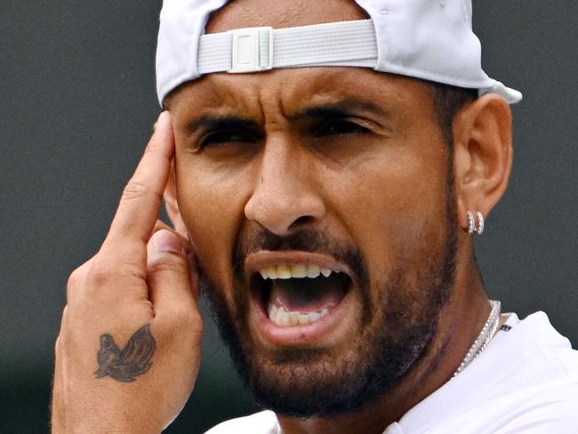 Australia's Nick Kyrgios reacts as he plays against Chile's Cristian Garin during their men's singles quarter final tennis match on the tenth day of the 2022 Wimbledon Championships at The All England Tennis Club in Wimbledon, southwest London, on July 6, 2022. (Photo by SEBASTIEN BOZON / AFP) / RESTRICTED TO EDITORIAL USE