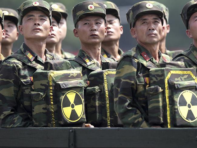 FILE - In this July 27, 2013, file photo, North Korean soldiers turn and look towards their leader Kim Jong Un from a military parade vehicle as they carry packs marked with the nuclear symbol during a ceremony marking the 60th anniversary of the Korean War armistice in Pyongyang, North Korea. Mark up another first for North Korea - two nuclear tests in one year. With few other options, or allies to rally behind it, this is how Pyongyang likes to play its cards in the power game that is northeast Asian politics. The question is whether it can play them well enough to get what it really wants: international recognition, security guarantees and, at the most fundamental level, its own continued survival. (AP Photo/Wong Maye-E, File)