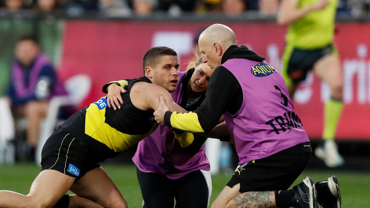 Dion Prestia of the Tigers is assisted by trainers after being concussed by Tom Stewart. (Photo: Getty Images)