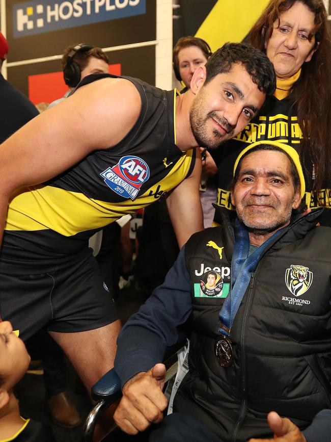 Marlion Pickett and his parents join Richmond’s celebrations. Picture: Michael Klein.