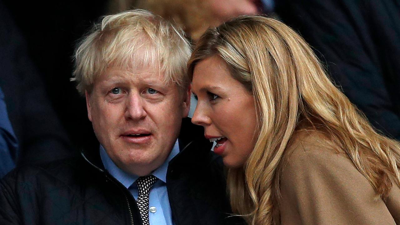 Prime Minister Boris Johnson with his partner Carrie. (Photo by ADRIAN DENNIS / AFP)