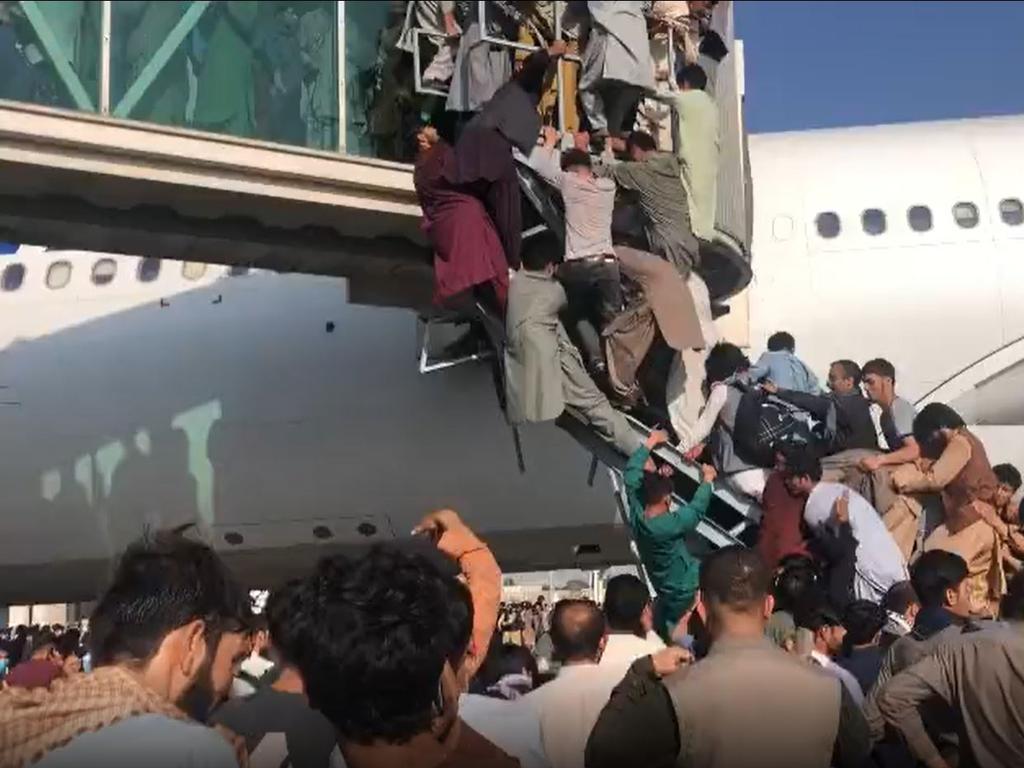 Civilians try to board planes to flee the Taliban. Picture: Ahmer Khan