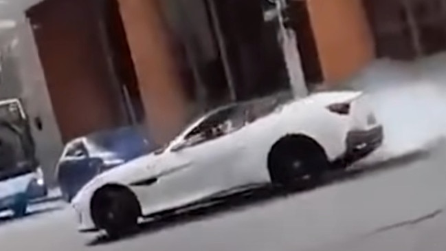 A Ferrari driver was filmed after allegedly running a red light and doing burnouts in Sydney’s CBD in May. Picture: 7 News