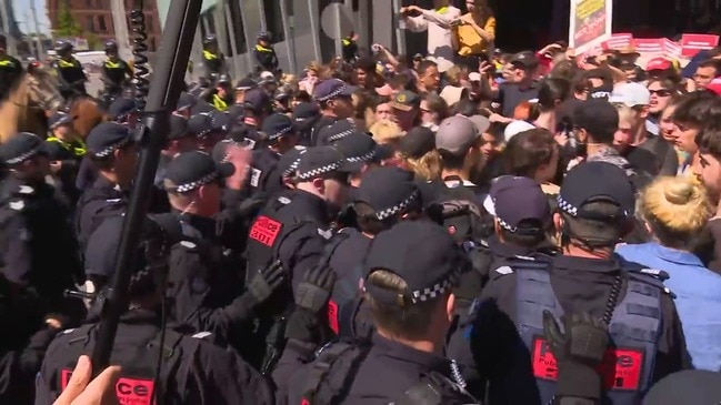 Police horses are used to push protesters away from Clarendon St