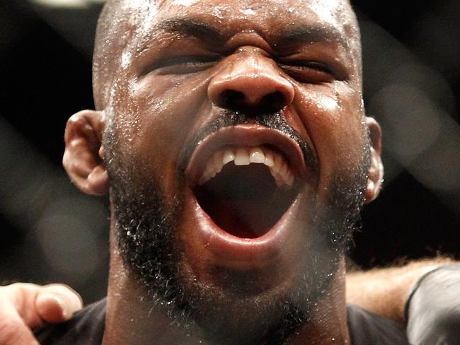 LAS VEGAS, NV - JANUARY 03: Jon Jones (C) yells out after defeating Daniel Comier in a light heavyweight title fight at the MGM GrandGarden Arena on January 3, 2015 in Las Vegas, Nevada. Jones retained his title by unanimous decision. (Photo by Steve Marcus/Getty Images)