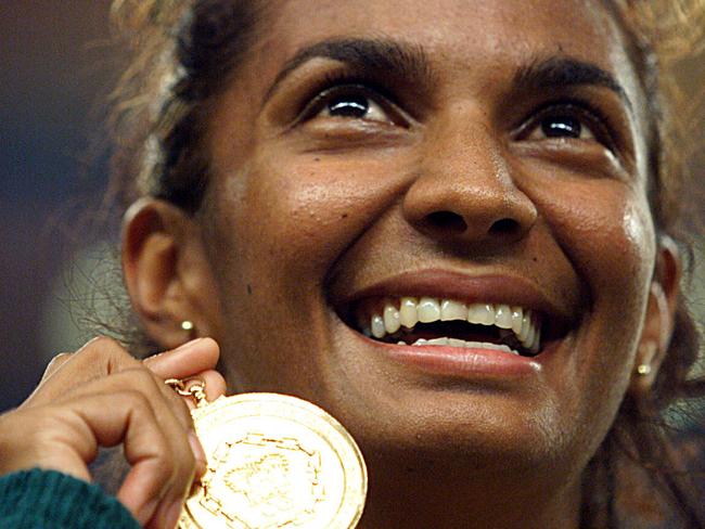 The Northern Territory’s Nova Peris shows off the gold medal she won in the women's 200m track final at the 1998 Commonwealth Games in Kualal Lumpur