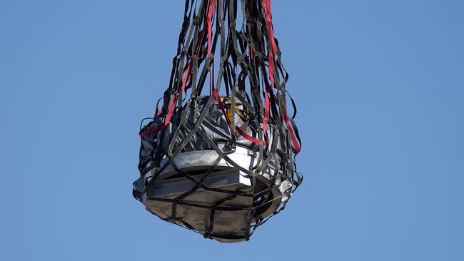 A helicopter delivers a space capsule carrying NASA’s first asteroid samples on September 24, 2023 to a temporary clean room in Utah. Picture: Rick Bowmer/POOL/AFP