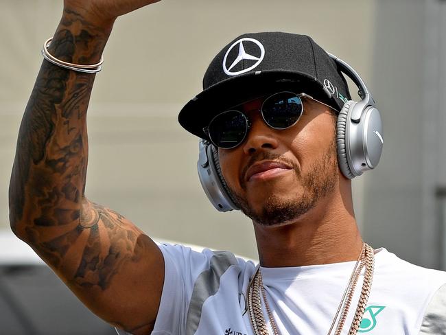 Mercedes AMG Petronas F1 Team's British driver Lewis Hamilton waves to the fans during the drivers' parade ahead of the Formula One Hungarian Grand Prix at the Hungaroring circuit near Budapest, on July 24, 2016. / AFP PHOTO / ANDREJ ISAKOVIC