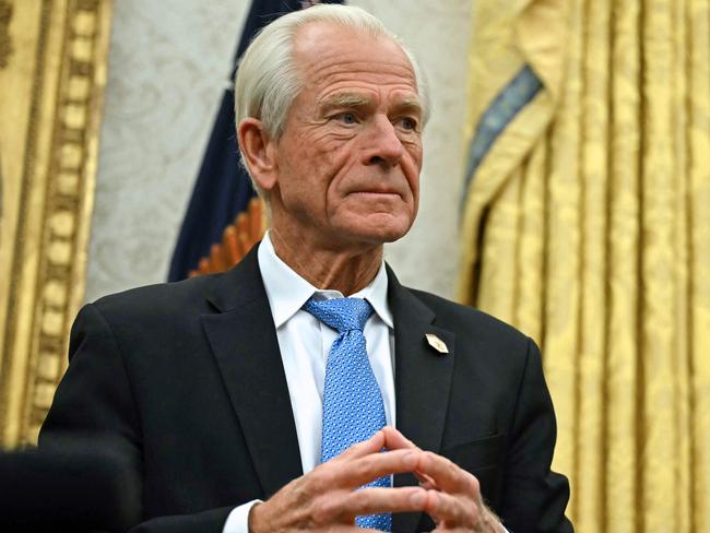 Counselor to US President Donald Trump, Peter Navarro listens to unseen US President Donald Trump speak to the press after signing an executive order, in the Oval Office of the White House in Washington, DC, on February 10, 2025. (Photo by ANDREW CABALLERO-REYNOLDS / AFP)