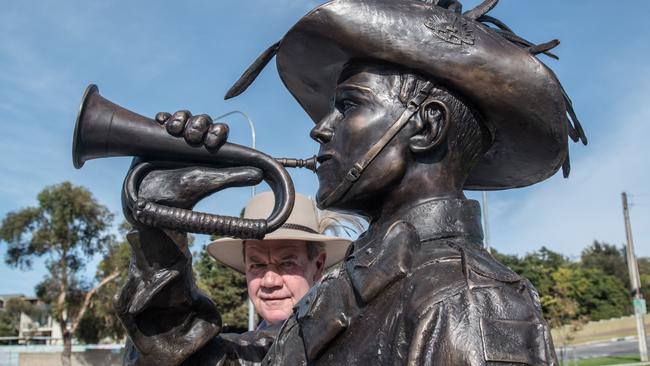 Peter Teakle next to the statue of World War I bugler Leonard Hall in Port Lincoln. Picture: Ivon Perrin