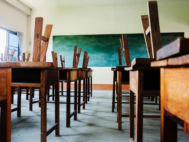 chair and table in class room with black board background, no student, school closed concept Picture: Istock