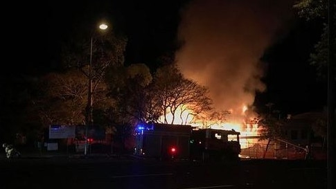 Firefighters battle a structure fire next to the Newmarket State School. Picture: Olivia Mowat