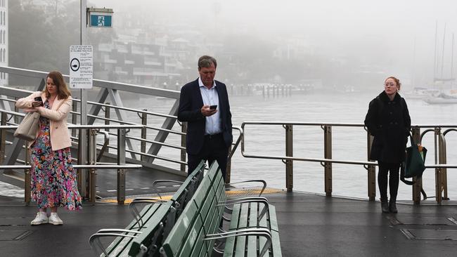 People are seen waiting for the ferry at McMahons Point near the Sydney Harbour Bridge. Picture: NewsWire/ Gaye Gerard