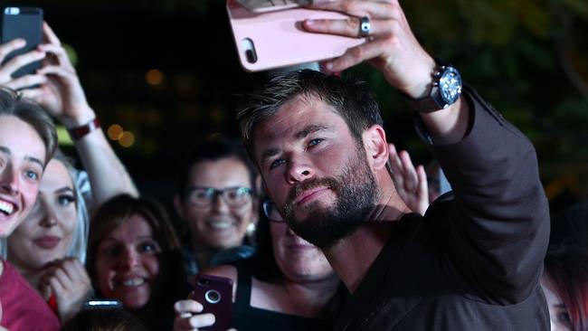 Fans pose with Chris Hemsworth on the red carpet. Picture: Lisa Maree Williams/Getty Images