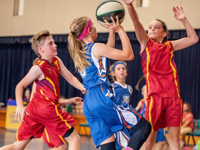 Gympie Basketball primary school grand finals - Lara Jenkin tries to shoot over MVP Caitlin Killian. Photo: Miguel Galy