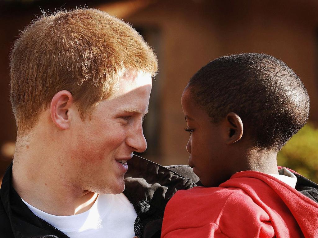 Prince Harry holds his old friend, Mutsu Potsane, in the grounds of the Mants’ase children’s home, while on a return visit to Lesotho on April 24, 2006 in southern Africa. The Prince was in the country to launch his new charity called ‘Sentebale’, which means ‘Forget me not’ in memory of his mother Princess Diana. Picture: Getty