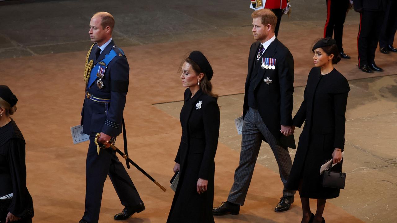 Harry and Meghan hold hands as William and Kate maintain separation. (Photo by Phil Noble – WPA Pool/Getty Images)