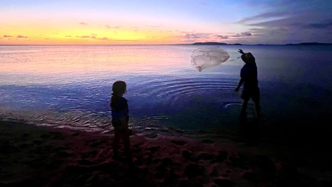 Carefully casting a bait fish net