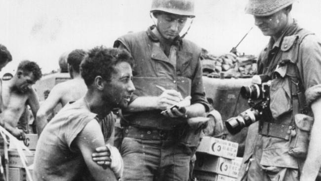 Hugh Lunn, centre, interviews a soldier.