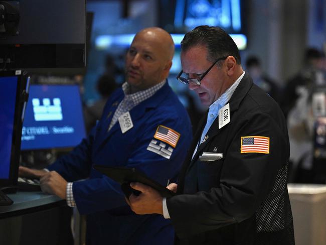 Traders work on the floor of the New York Stock Exchange (NYSE) during morning trading in New York on August 23, 2024. US Federal Reserve Chair Chair Jerome Powell said on August 23 that the "time has come" for the US to start cutting interest rates, adding that his "confidence has grown" that the battle against inflation is on track. "The time has come for policy to adjust," he said in a keynote speech at the Jackson Hole Economic Symposium in Wyoming, according to prepared remarks. (Photo by ANGELA WEISS / AFP)