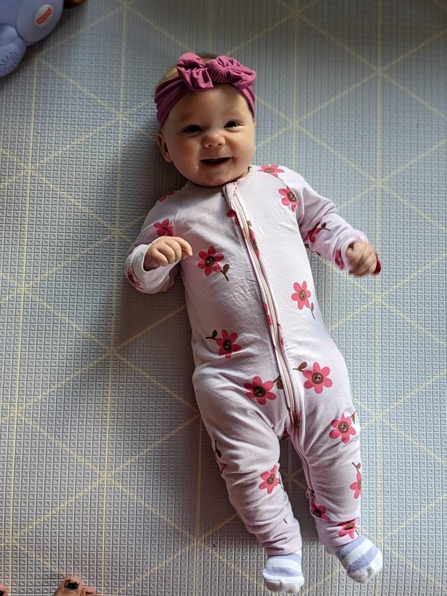 Ravenna D’Agostino, five months old. Ravenna is our feisty and bubbly, double rainbow baby. She has the most infectious smile and laugh, and enchants all those who meet her with her cheeky grins, giggles, and coos. Ravenna truly knows her own mind. We have nicknamed her “our little mandrake” for when she is annoyed, she uses her high pitched, ear piercing screams to get what she wants. Our sweet Ravenna absolutely loves the outdoors, especially being by water. We often frequent Surf Coast beaches, with Urquhart’s Bluff and Anglesea being favourite spots for our family. Ravenna has experienced several camping trips so far, with swimming in the Murray River and exploring the Otway Forests being highlights. She loves being out in nature and already displays a fond affection for all animals, in particular, our three legged cat, Jackson. Ravenna is an exceptional little lady and we adore her endlessly.