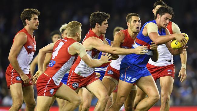 Tom Boyd is swamped by Swans players.