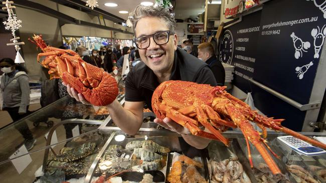 George Milonas, with ‘the Cray Twins’, is flying in more lobsters for his store at Melbourne’s Queen Victoria Market after he sold out on Wednesday. Picture: David Geraghty