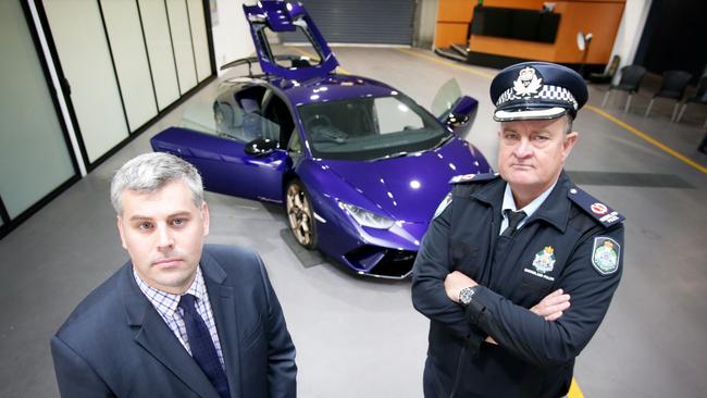 Police Minister Mark Ryan and Acting Assistant Commissioner Ray Rohweder with the $600,000 custom Lamborghini before it goes up for police auction this month. Picture: Steve Pohlner