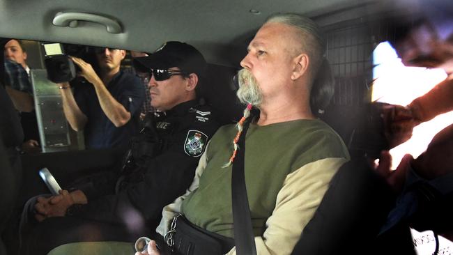 Troy James O'Meara is driven under arrest by police to the Police Watch House in Brisbane after being arrested for the 1983 murder of Linda Reed on the Gold Coast. (AAP Image/Dave Hunt)