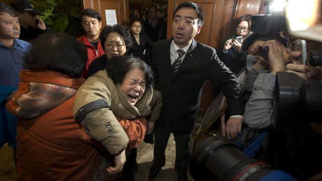 A relative of one of the Chinese passengers aboard Malaysia Airlines Flight MH370 collapses in grief after being told of the latest news in Beijing, China on March 24, 2014. Picture: AP