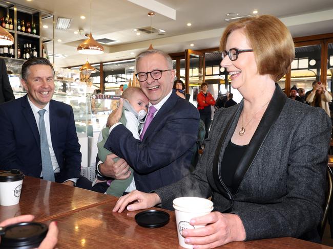 Anthony Albanese having a coffee with Julia Gillard in the SA electorate of Sturt. The Labor leader holds Charlie Butler, three months, son of Mark Butler (left). Picture: Sam Ruttyn