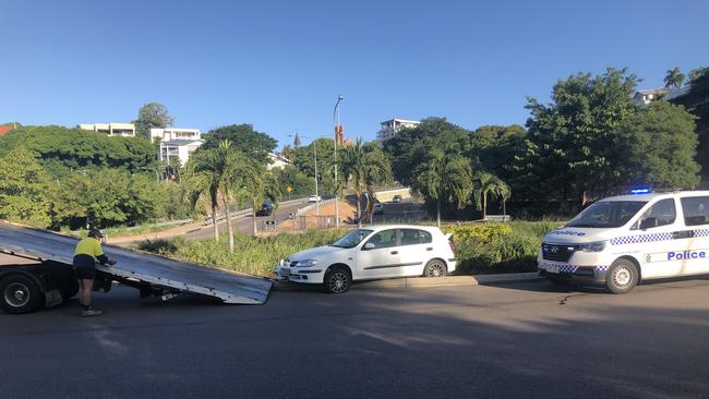 A crashed car is removed from a roundabout on Eyre St, North Ward.