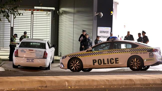 Police with the damaged stolen car in Angas St. Picture: Dean Martin