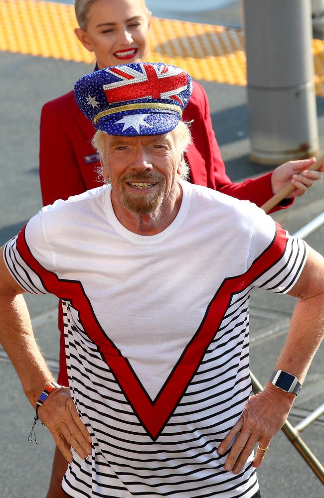 Sir Richard Branson greets commuters on a Sydney Ferry to announce Virgin Voyages and Virgin Australia will offer flight and cruise packages for Aussies wanting to cruise the Caribbean. Picture: Toby Zerna