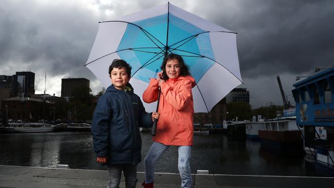 Henry Foster 4 with sister Adelin (Adelin) Foster 7 of Hobart out on the waterfront despite the rain. Picture: NIKKI DAVIS-JONES