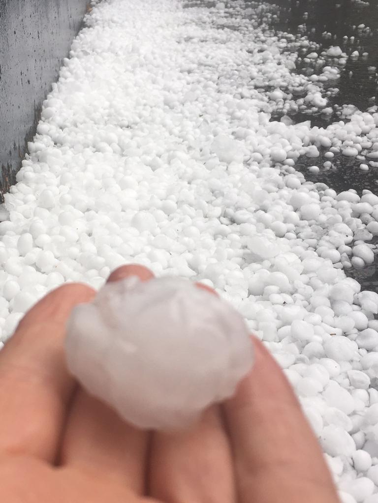 Huge hail stones pile up outside news.com.au offices in Sydney.