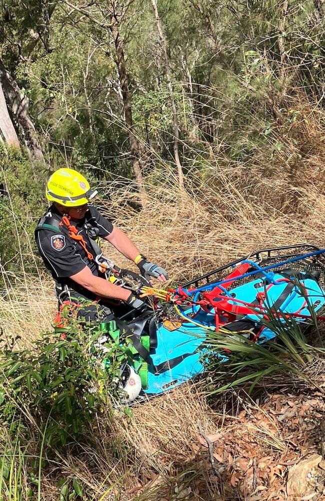 A man has been rescued after his car went down a ravine, leaving him trapped for a night before he was discovered. PHOTO: QAS