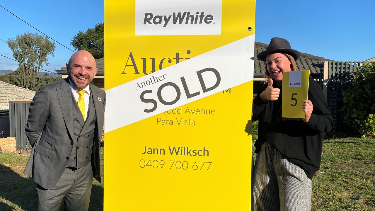 <b>LUCKY NO. 5:</b> Ray White auctioneer John Morris with Gemma after the auction of 13 Ellwood Ave, Para Vista in May. The property settled on June 21. Picture: supplied.