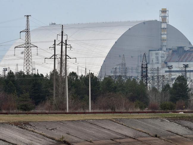 (FILES) A file picture taken on April 13, 2021 shows the giant protective dome built over the sarcophagus covering the destroyed fourth reactor of the Chernobyl Nuclear Power Plant ahead of the upcoming 35th anniversary of the Chernobyl nuclear disaster. - Ukraine's Chernobyl nuclear plant says 'completely halted' over Russian offensive. (Photo by Sergei SUPINSKY / AFP)