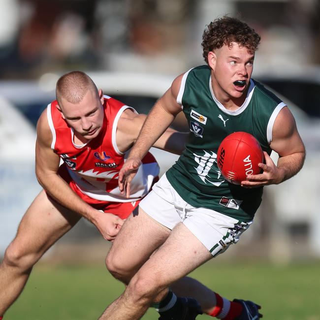 Shepparton Swans’ Zac Clohesy tries to halt Echuca’s Fraser Brooks.