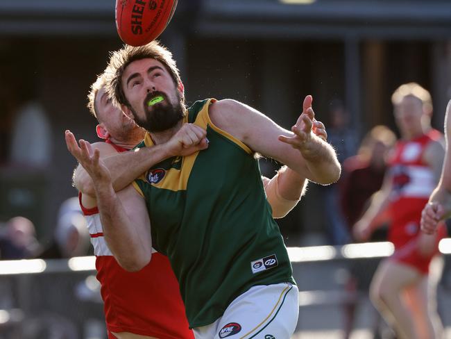 NFNL footy: Lalor v Old Eltham Collegians at Lalor Reserve, Lalor, 03 July 2021.  Old Eltham Collegians no 29 marks in from of LalorÃs no 12Picture : George Salpigtidis