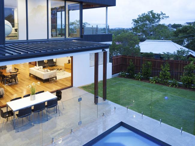 A frameless glass pool fence offers a seamless transition from pool to entertaining area