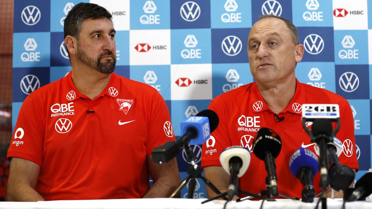 John Longmire hands over to Dean Cox. Photo: Phil Hillyard.