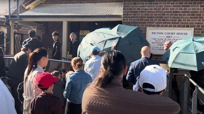 Tyrell Edwards is shielded from the media as he walks into Picton Local Court. Picture: NCA Newswire / Steve Zemek.