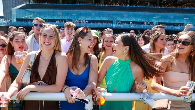 Racegoers soak up the fun on the rails at Randwick. Picture: Justin Lloyd