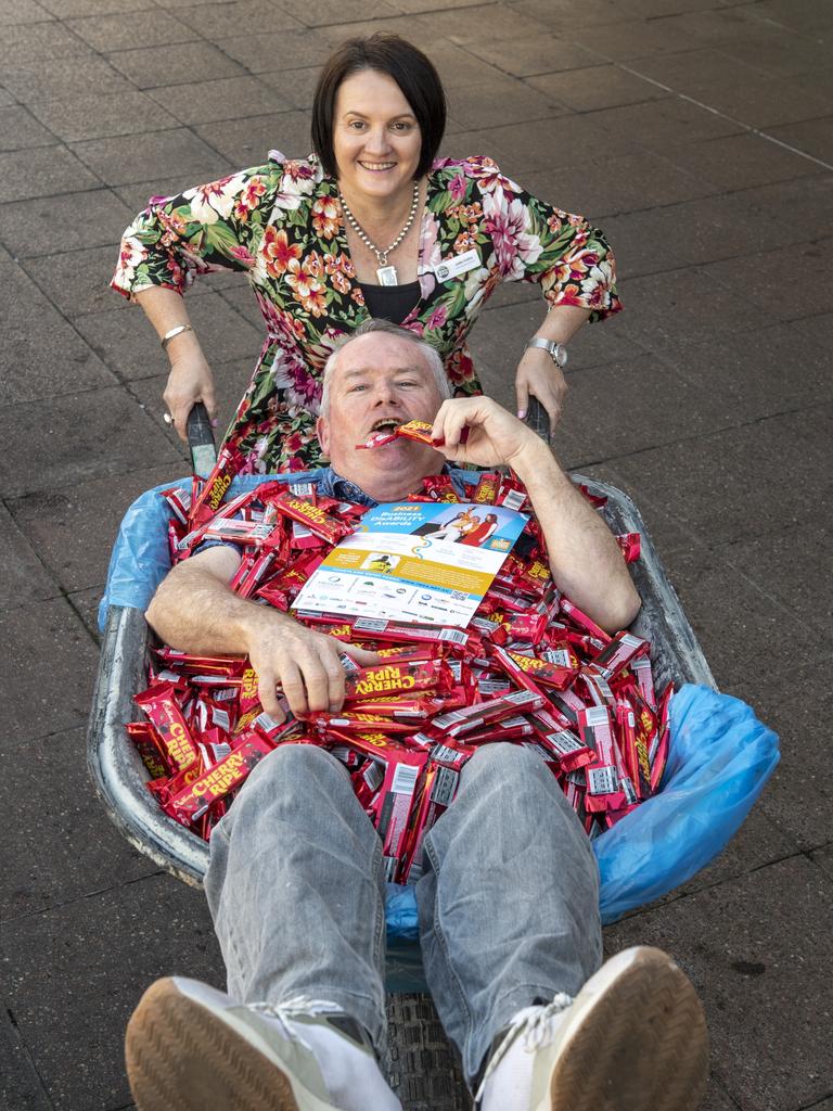 YellowBridge COO Jodie Collins and volunteer Daryl Nicholson giving away chocolate bars in the CBD to raise awareness for the Disability Business Awards. Picture: Nev Madsen.