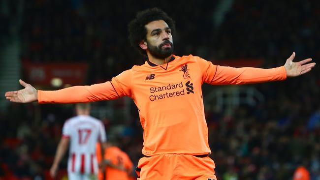 Liverpool's Egyptian midfielder Mohamed Salah celebrates scoring their third goal during the English Premier League football match between Stoke City and Liverpool at the Bet365 Stadium in Stoke-on-Trent, central England on November 29, 2017. / AFP PHOTO / Geoff CADDICK / RESTRICTED TO EDITORIAL USE. No use with unauthorized audio, video, data, fixture lists, club/league logos or 'live' services. Online in-match use limited to 75 images, no video emulation. No use in betting, games or single club/league/player publications.  /