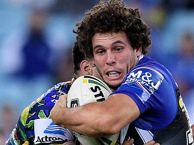 Adam Elliott of the Bulldogs is tacked by Tepai Moeroa (left) and Mitchell Moses of the Eels during the Round 10 NRL match between the Canterbury-Bankstown Bulldogs and the Parramatta Eels at ANZ Stadium in Sydney, Friday, May 11, 2018. (AAP Image/Dan Himbrechts) NO ARCHIVING, EDITORIAL USE ONLY